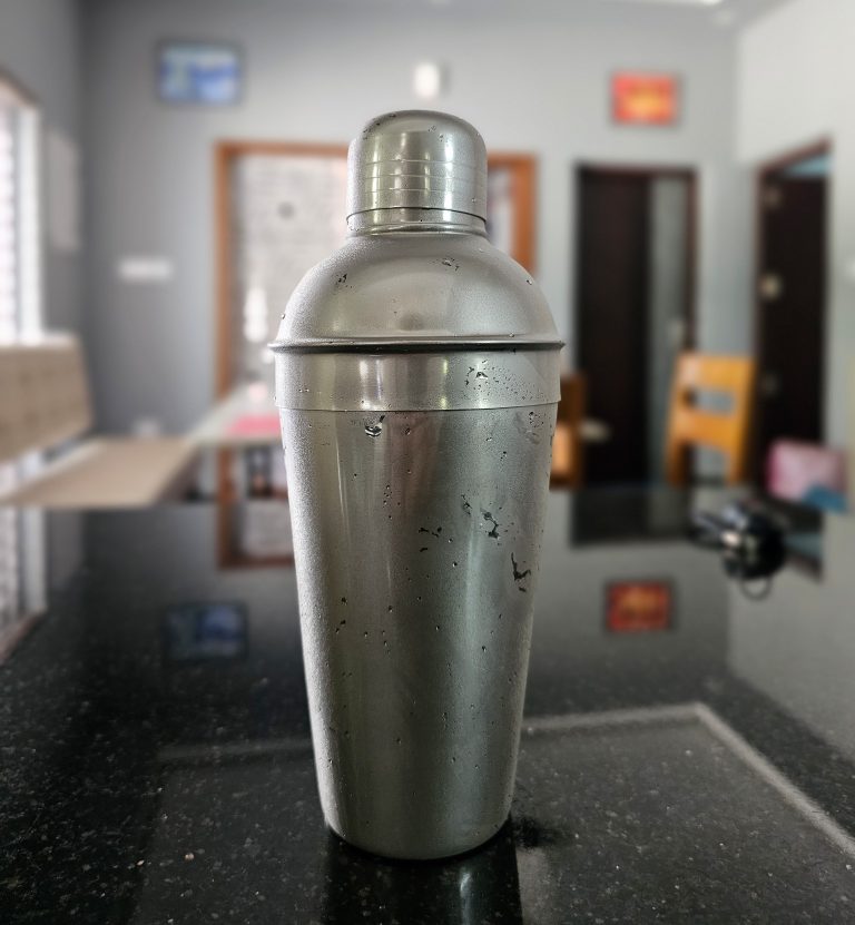 Frosted steel cocktail shaker on a granite countertop.