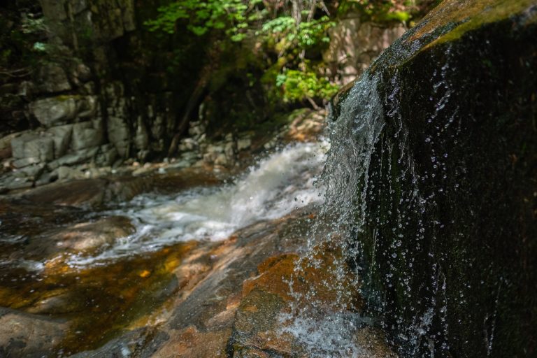 Water cascades down the steep glacial erratics in the White Mountains of New Hampshire, USA