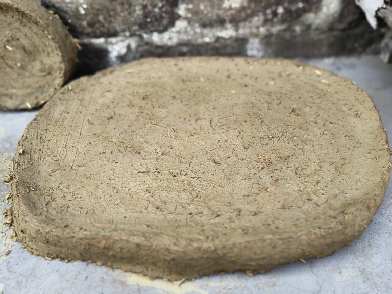 A close-up of a stove plateform built with soil