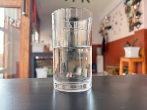 A cup of clean water on a table.