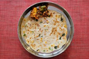 Mixed vegetable dosa served with paneer butter masala. 