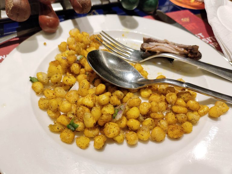 A plate of food with a fork and spoon on it.