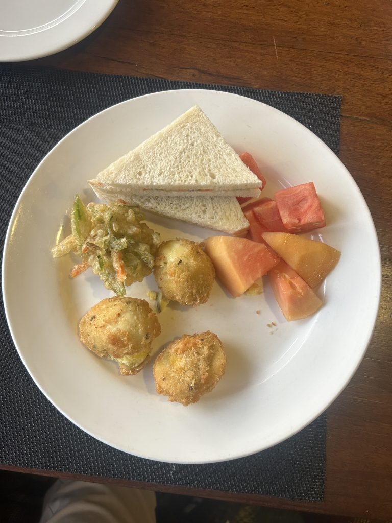 Sandwiches, papaya along with vegetable tempura and crunchy hard-boiled eggs.