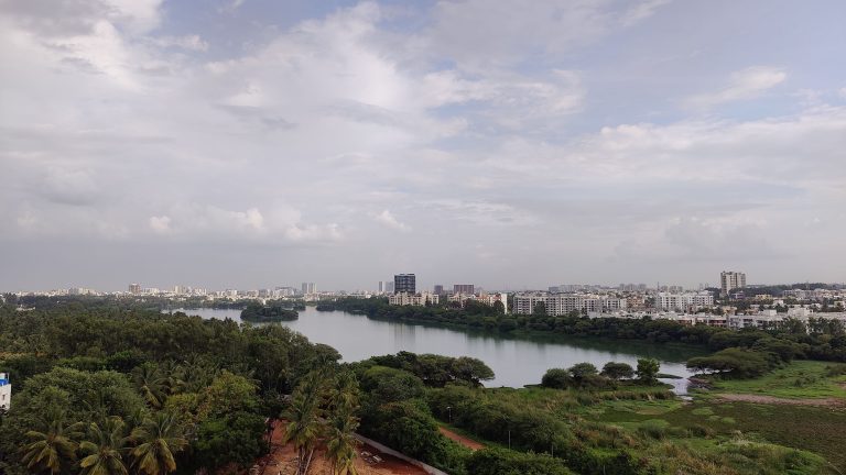 Metro city with beautiful view of lake and greenery.