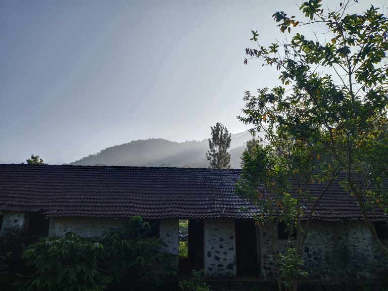 A broken building with mountain background.