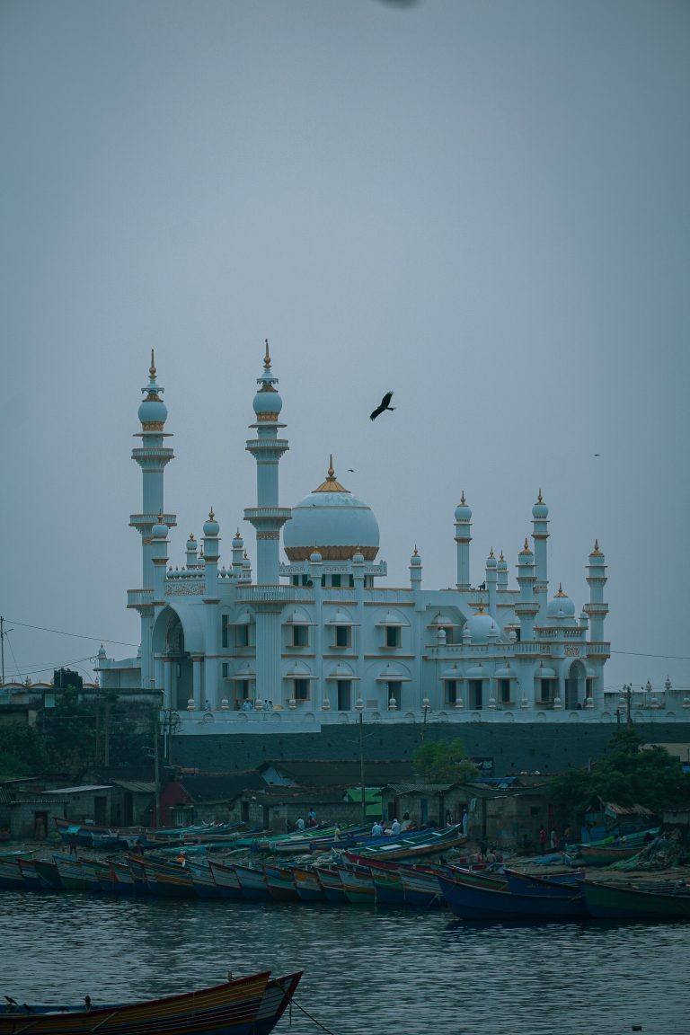 Serene beachside setting with a majestic Grand Mosque, framed against the backdrop of a picturesque horizon.