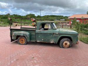 An old green Dodge pick-up with flat tires at the farm of Hofi Cas Cora on the island of Curaçao.
