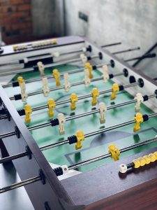 Foosball Table with white and yellow players. 