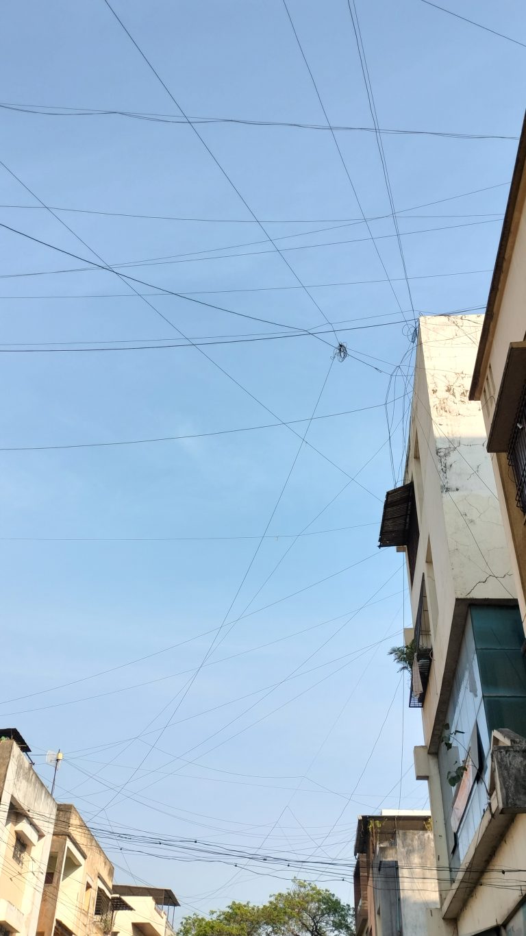 A mesh of cable network over buildings in city