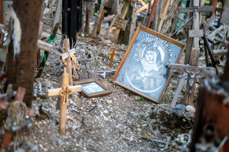 Framed picture of Virgin Mary surrounded by crosses in various different sizes in the Hill of Crosses, Lithuania.