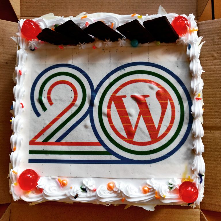 A birthday cake celebrating WordPress 20th birthday.