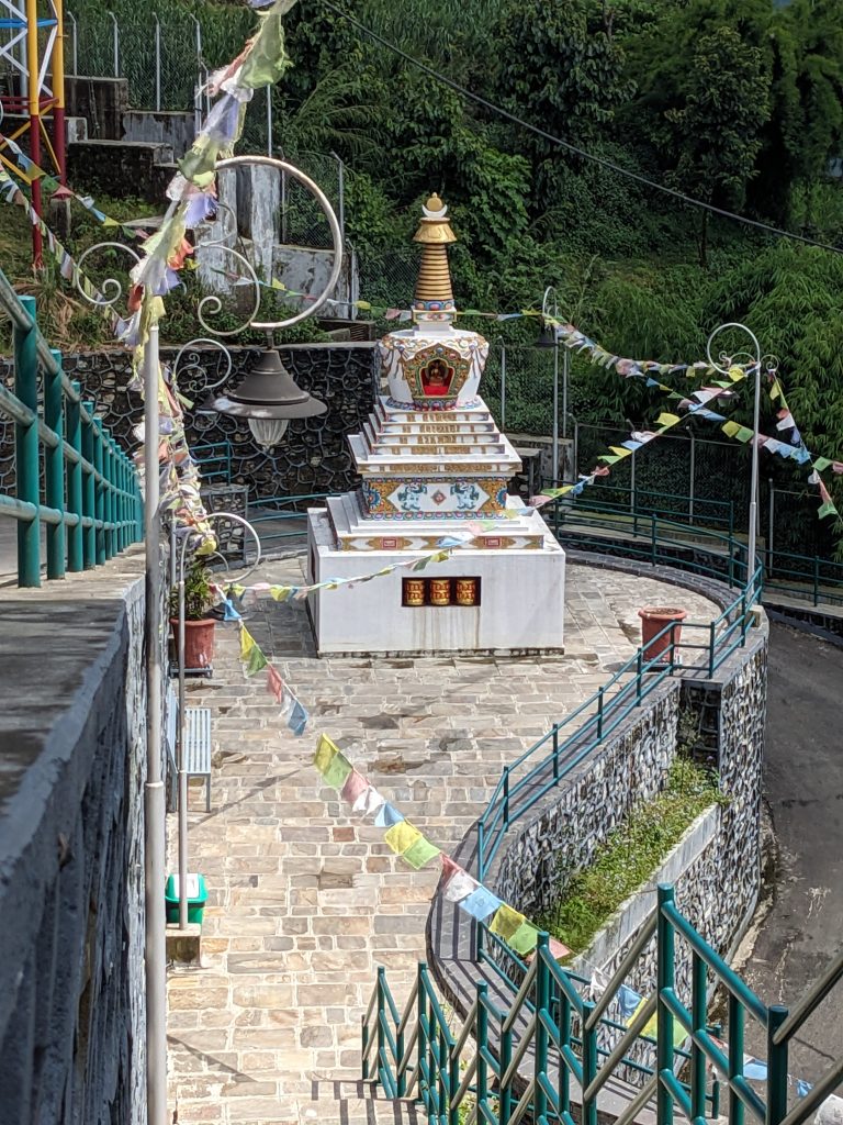 Serene beauty: a small white stupa gracing the hillside at Peaceful Temple, Pokhara, Nepal.