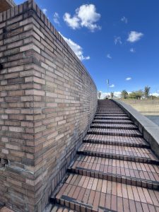 Flight of stairs, bricked wall, blue sky in the background