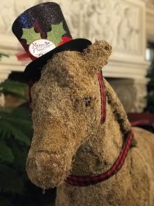 A decorative horse made from Spanish moss wearing a black top hat that says “Merry Christmas” at The Breakers mansion in Newport, Rhode Island.
