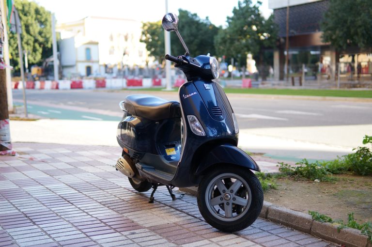 Dark blue motorcycle parked in the street.