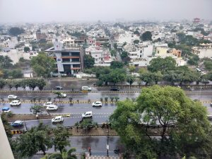 View of the buildings and roads in the city from the top during a rainy day. 