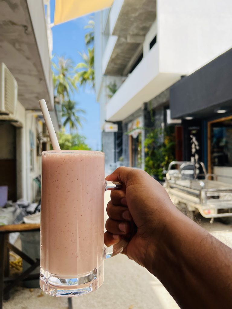 A man holding smoothie