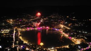 An aerial view of pushkar lake at night with fireworks.
