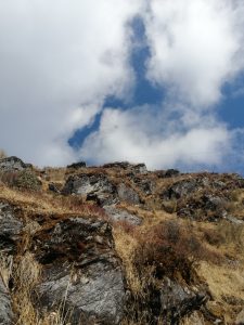 Dry hill with big stones with a clear blue sky in Nepal.