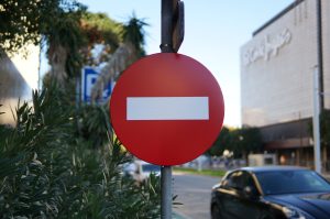 Red one-way street sign