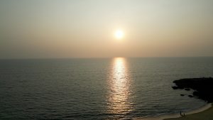 Sunset from beach, sun shades on the sea.