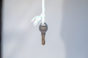 A key hanging on a white thread with made in Turkey written on it.