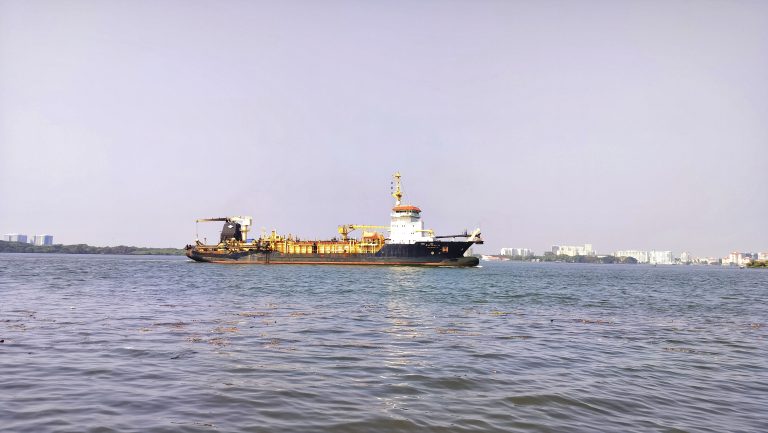 A huge ship is cruising in the middle of the sea.