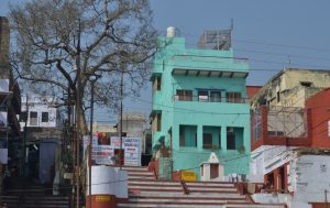 Colourful green building at Ganga river ghat