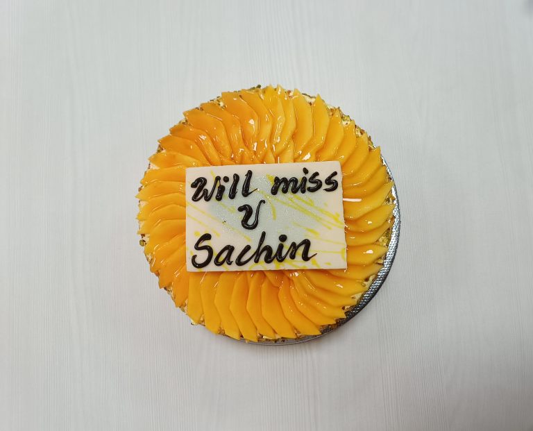 A farewell cake adorned in yellow hues featuring a heartfelt “will miss you” message.