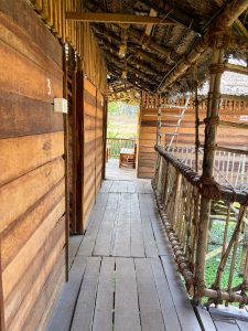 View larger photo: The wooden corridor of a traditional kerala style building with coconut leaf roof