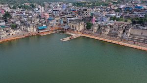 aerial view of Pushkar Lake with buildings around it. 