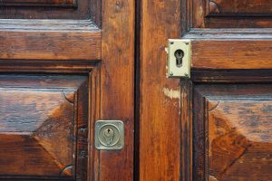 Old wooden door with two key holes