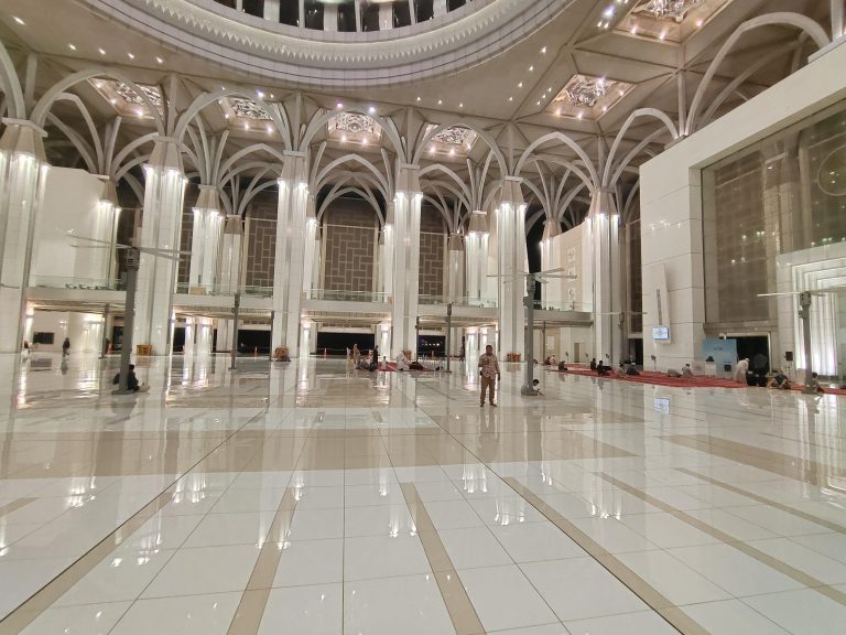 A grand mosque interior with stunning domed ceiling.