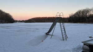 Early morning view of a metal slide on the frozen beachfront of Little Elkhart Lake at Camp Anokijig (Plymouth, Wisconsin)