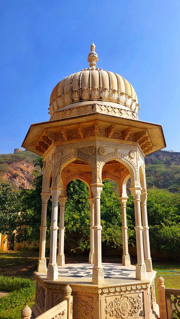 A dark yellow colored stone dome in Gaitor Ki Chhatriyan. Photo taken from Jaipur, Rajasthan.