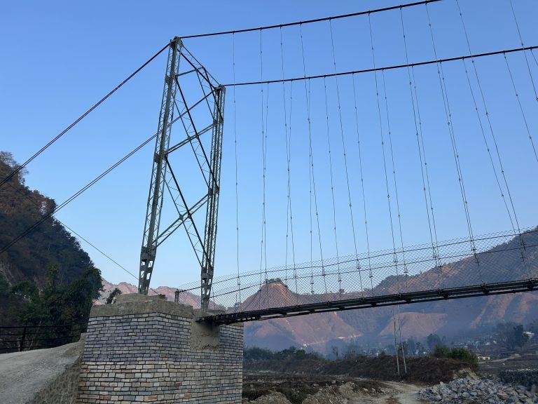 A close-up of the connectors on a suspension bridge pole.