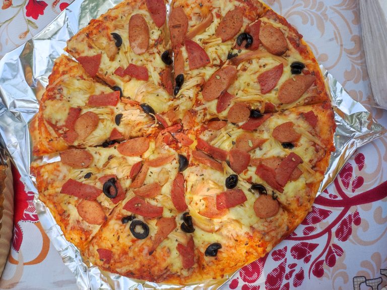 Pizza topped with cheese and sausage.