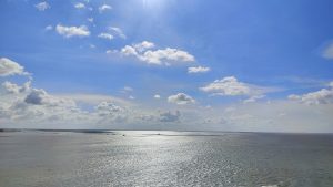 Bright blue skies and white fluffy clouds over the Padma River
