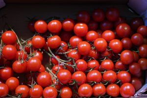 Crate of ripe cherry tomatoes on the vine