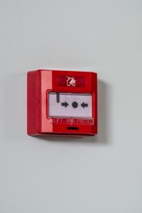 Fire alarm call point on the wall.