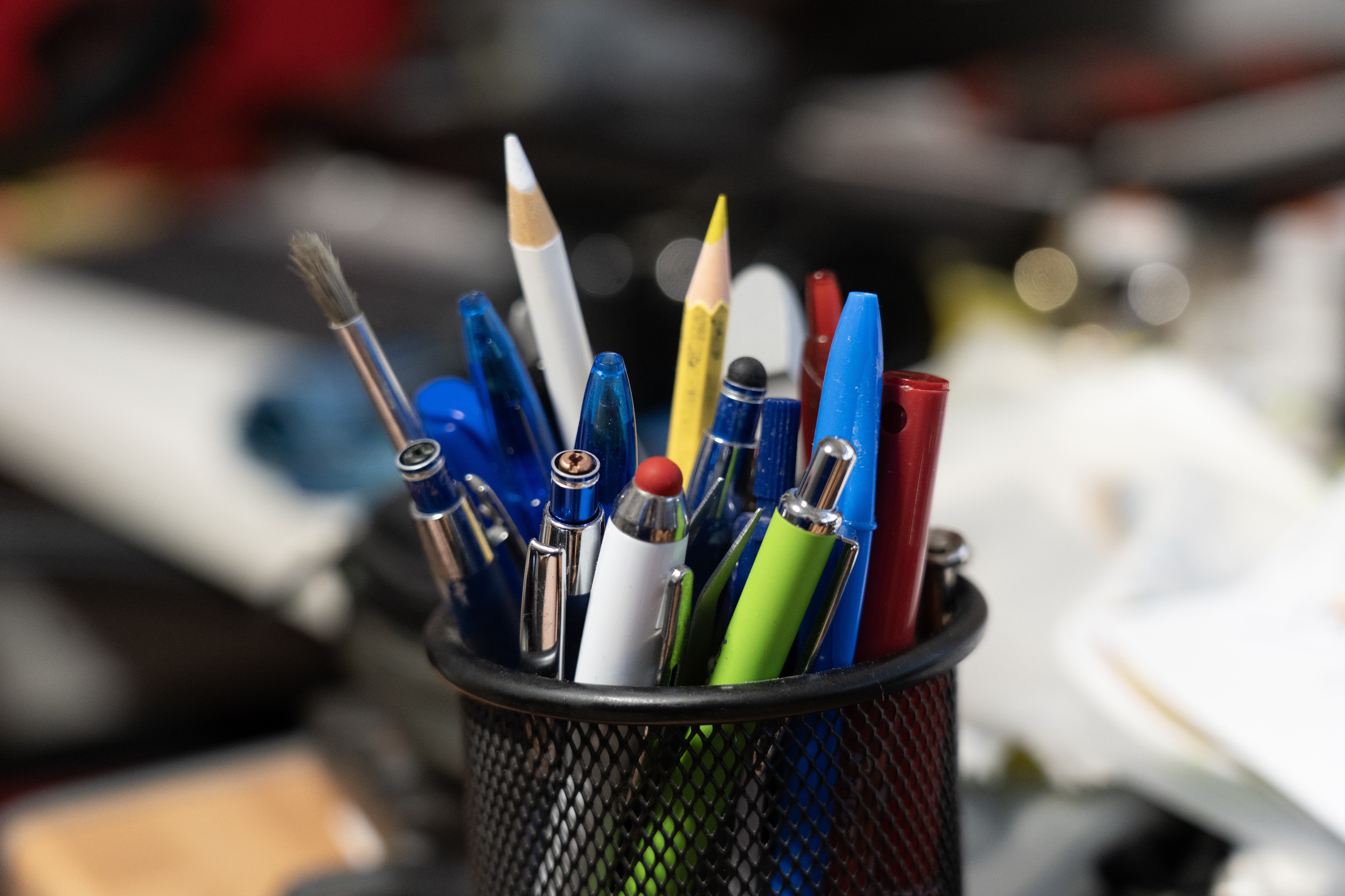 Various writing utensils in a pen pot.