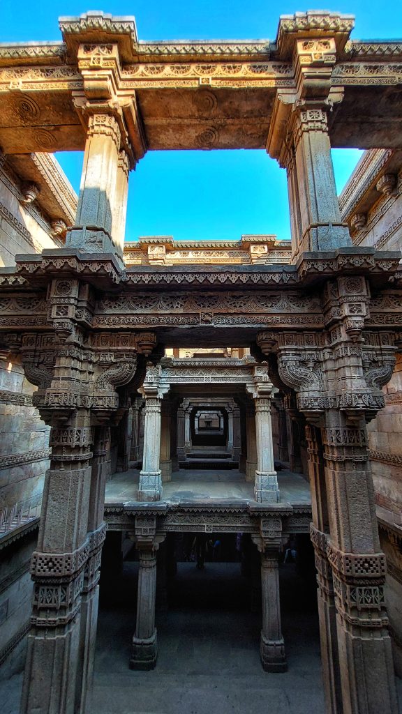 Adalaj Stepwell is a beautiful structure, descending five stories deep in Ahmadabad, India. It was built in 1499 to hold water, provide refuge to travelers and local people, and offer spiritual sustenance.