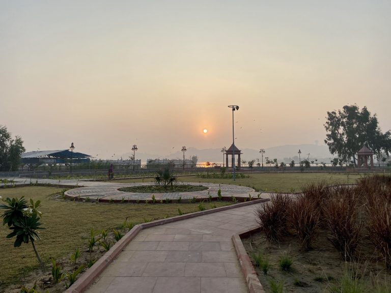 Sunrise over a park with a river in the back