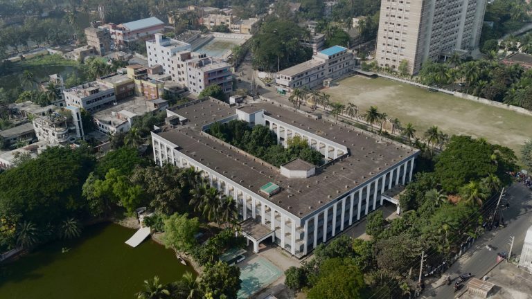 Drone photo of a townhall building with trees around it.