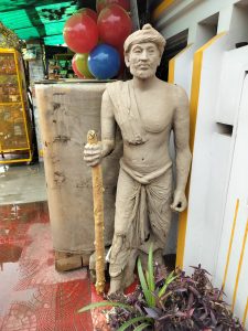 A beautiful clay sculpture of an old man leaning on a walking stick, showing wisdom and strength. It's a timeless tribute to nature and the human spirit.