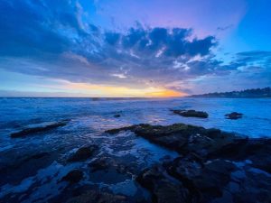 Sunrise over waves on the water