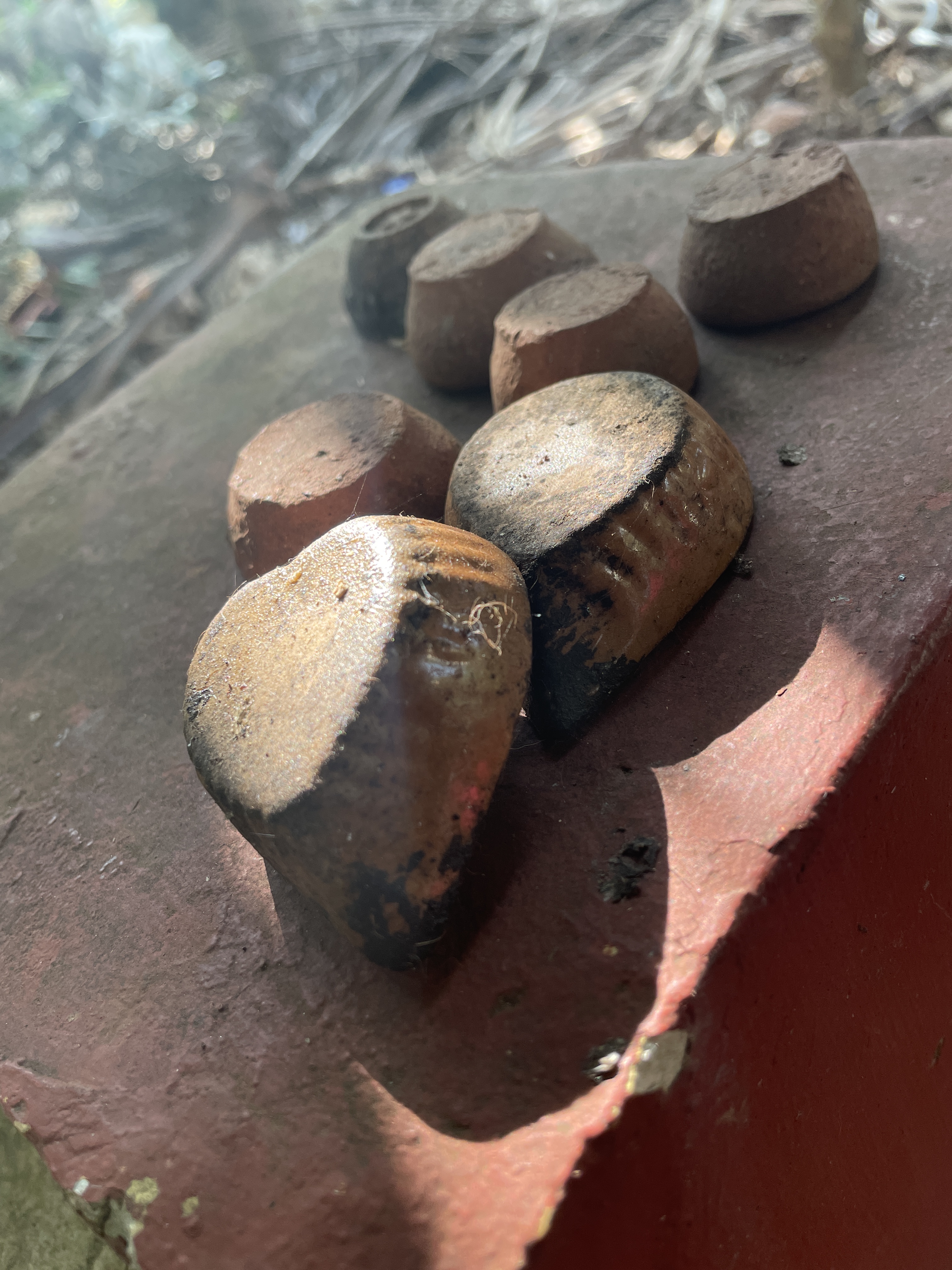 A group of seven clay diyas kept upsdie down.