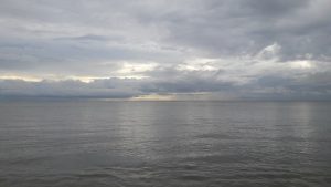 A grey sky over a calm sea