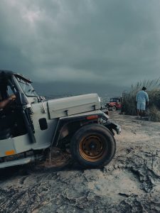  Jeeps trekking on mountain top on a cloudy day. 