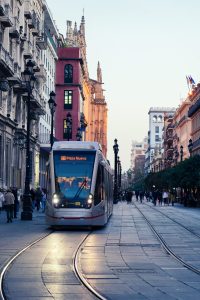 Front view of an incoming tramway on a busy street.